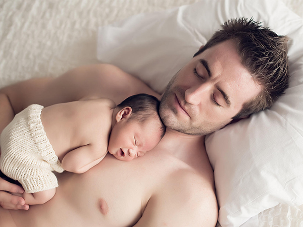 Top baby care skills every father needs to be lying on